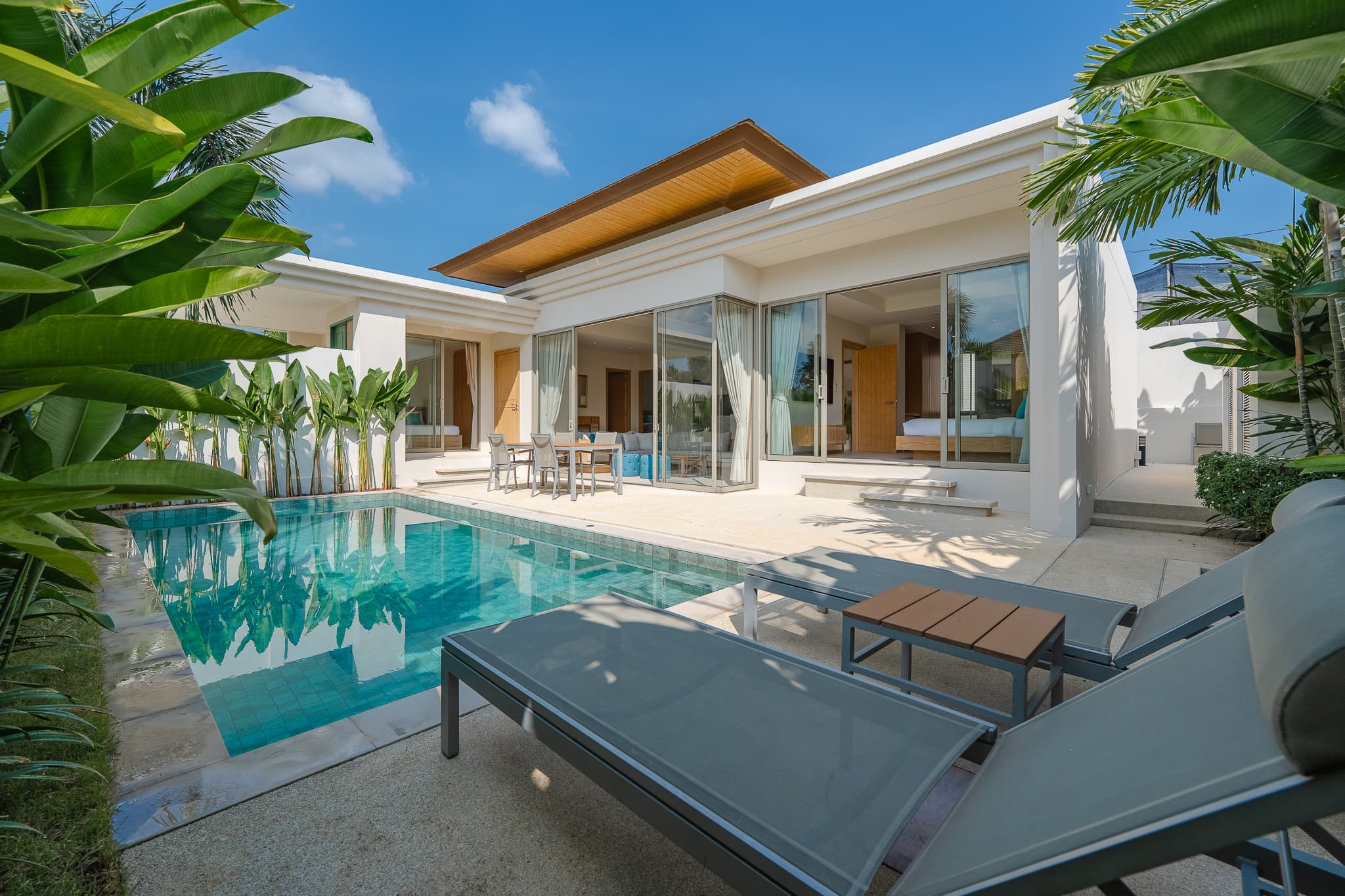 Private pool villa in Phuket with sun loungers and tropical planting