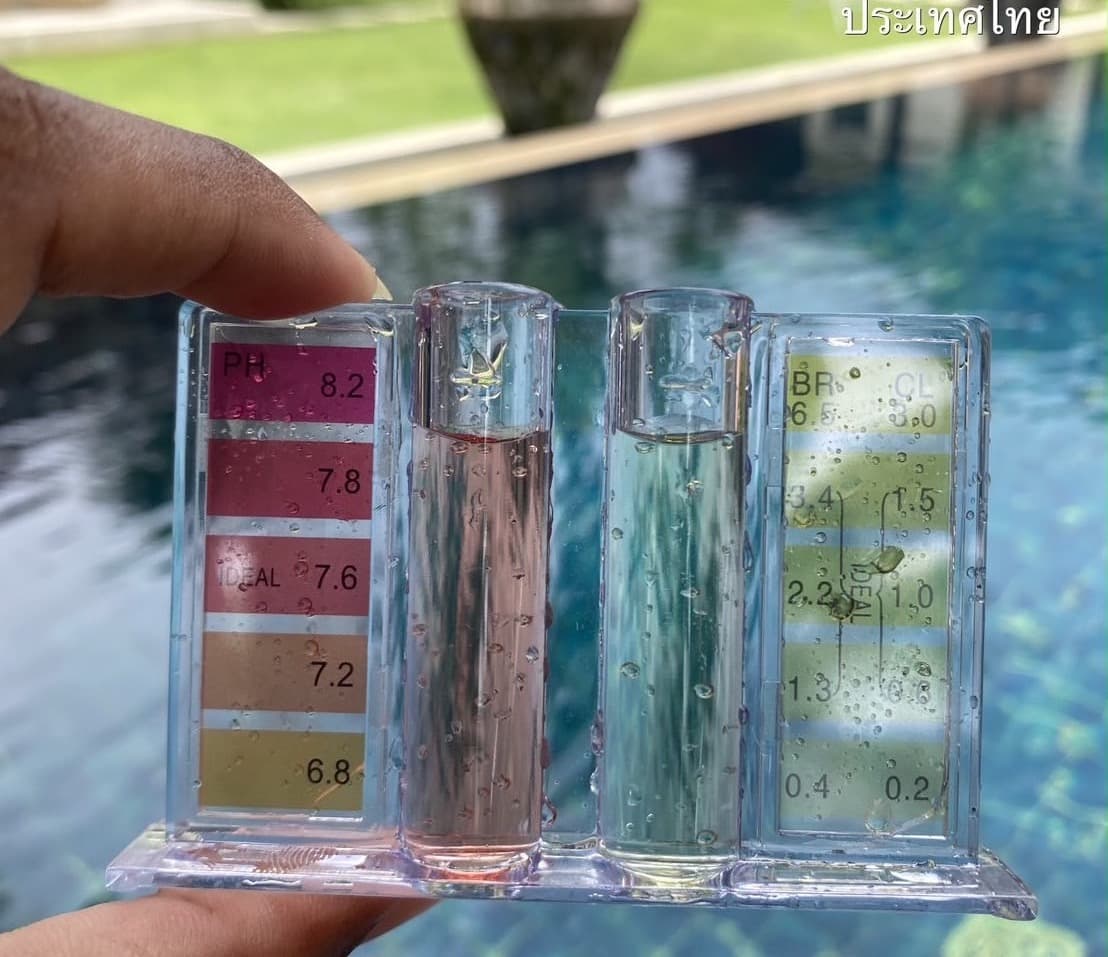 Pool water test kit held above a villa pool in Phuket, showing the pH reading